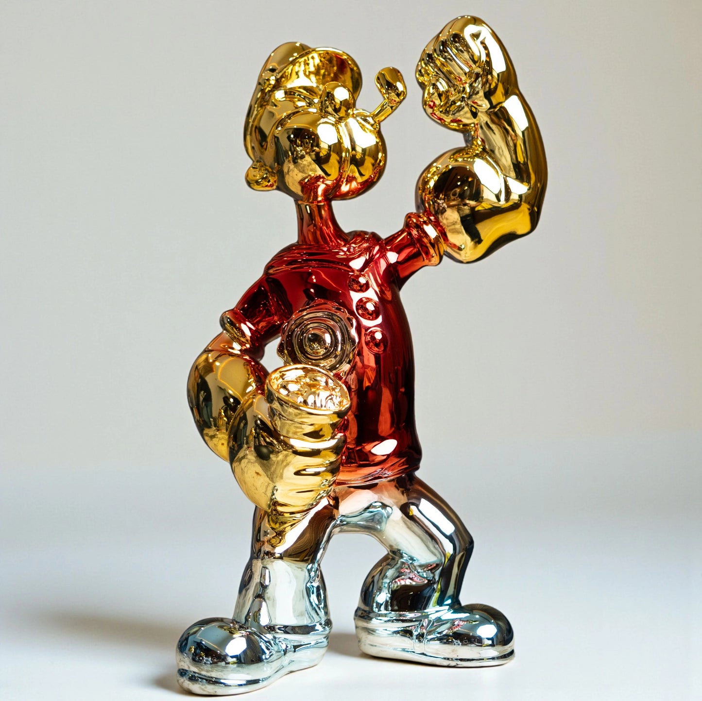 Red, gold, and silver metallic resin figurine in a dynamic pose — luxury electroplated decorative sculpture by Ghar Art.