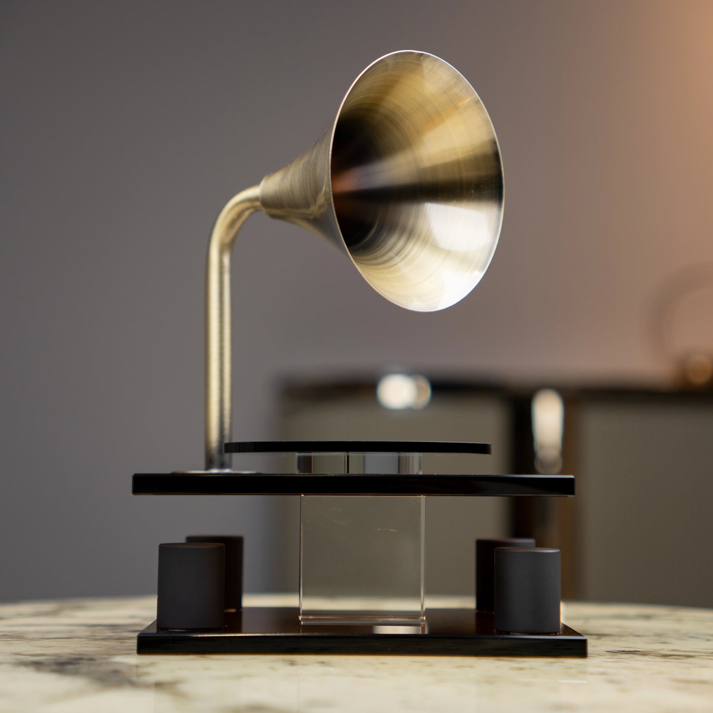 black retro-style acoustic amplifier decor piece with gold funnel top