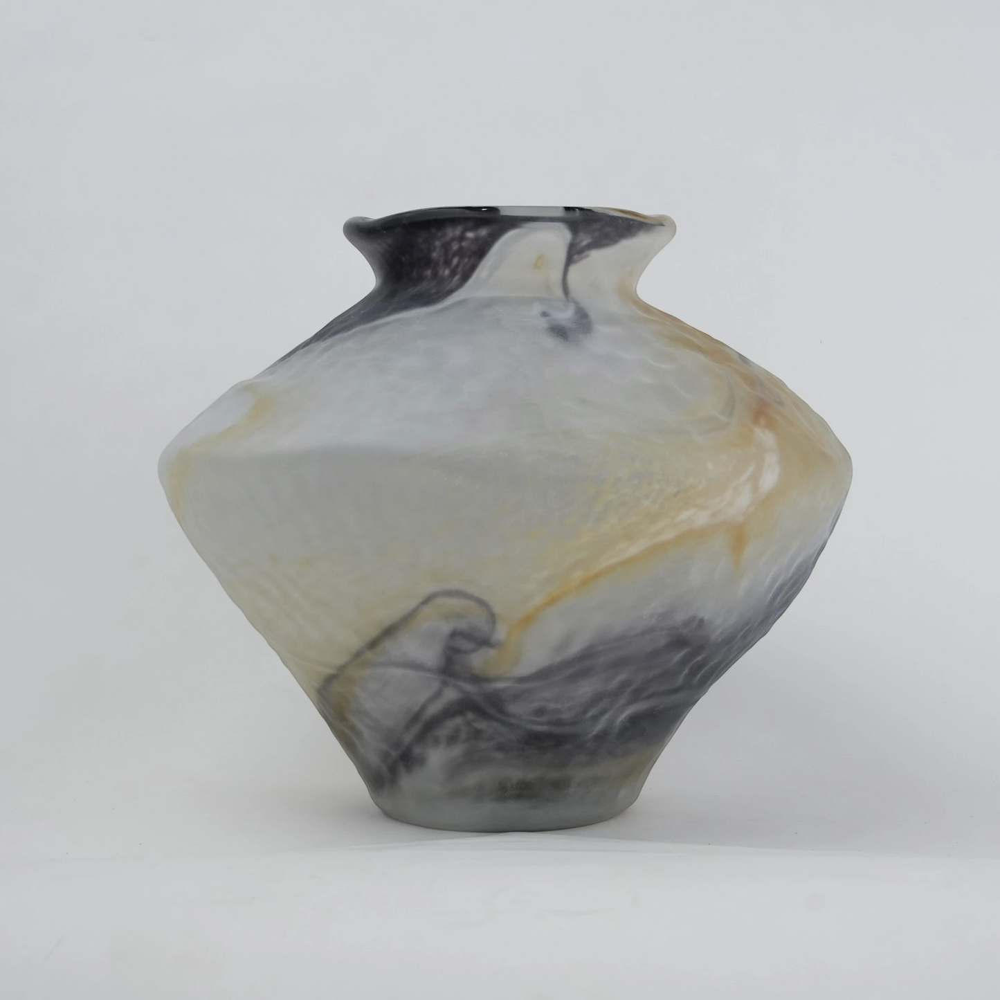 White marble art glass vase with organic pattern and wide asymmetrical form.