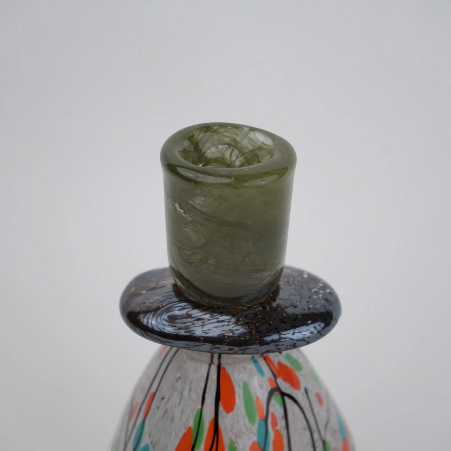 multicolor abstract glass candle holder with orange green accents and black drip design