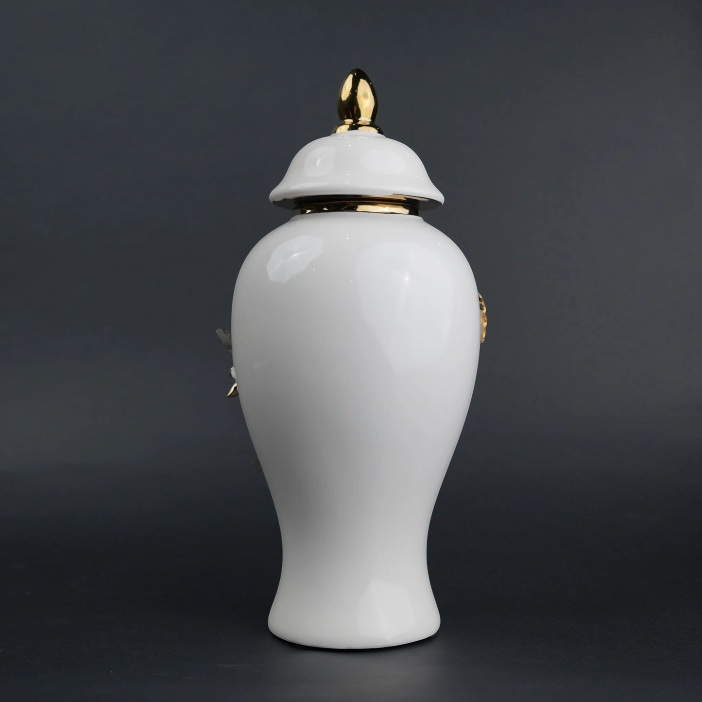 White ceramic decorative jar with sculpted gold floral design and lid