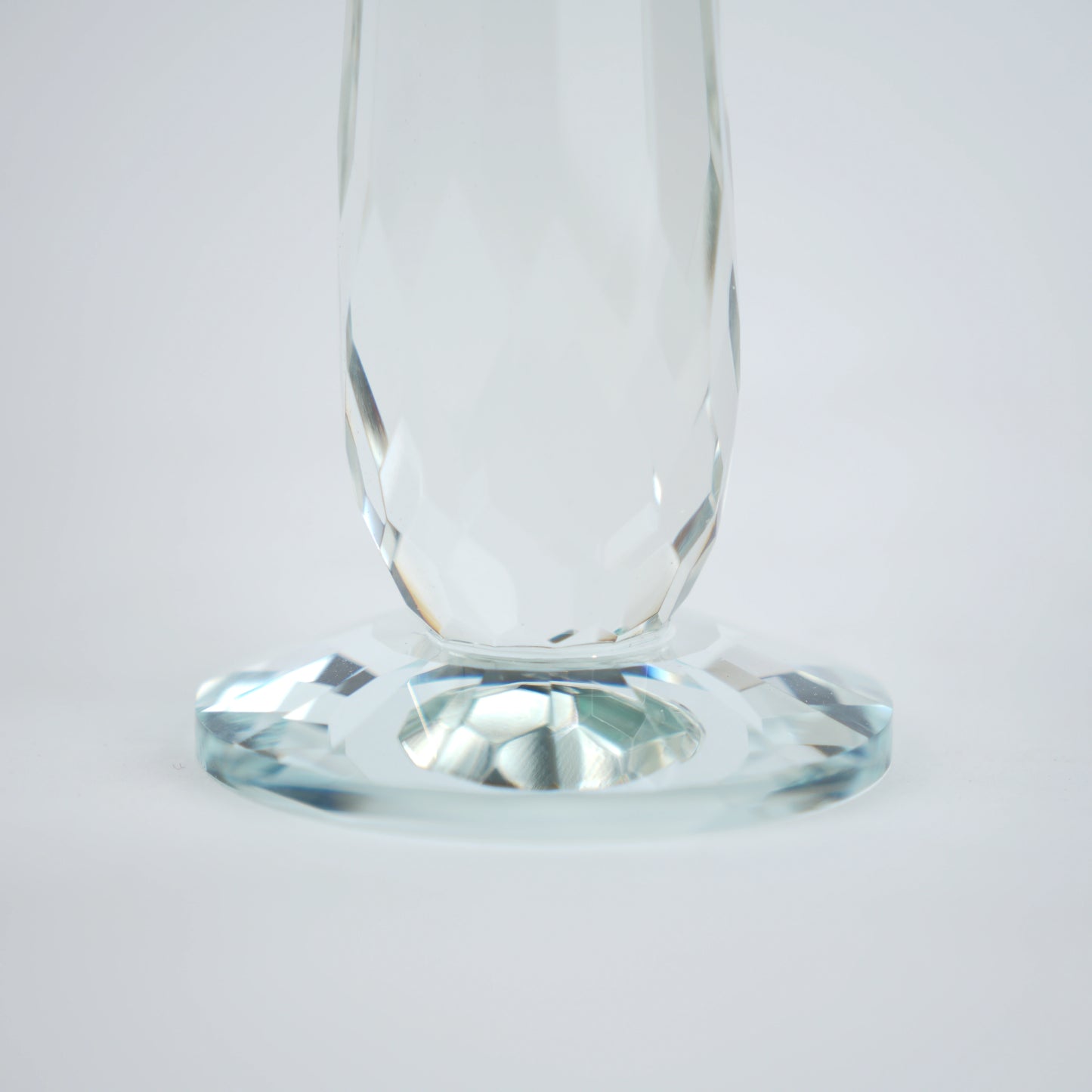 Emerald green glass lotus candle holder with faceted petals and clear crystal base