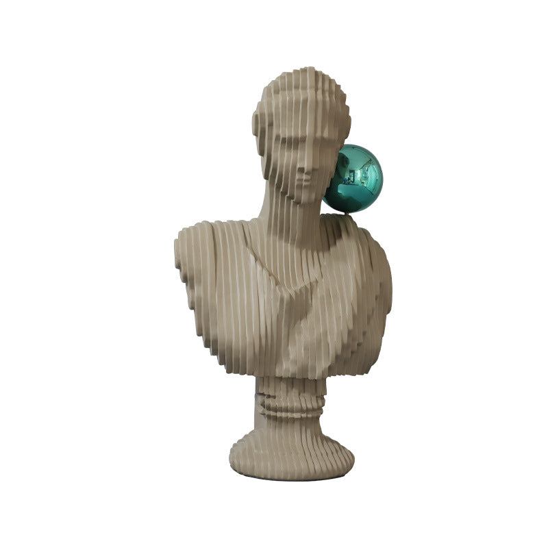 Brownish grey stone-inspired abstract bust sculpture designed as a modern decorative accent for neutral interiors