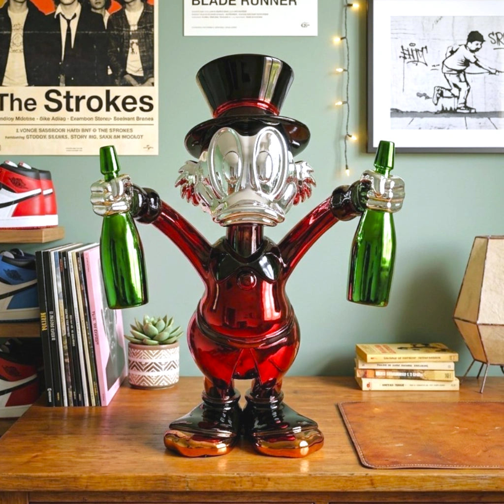 red duck figurine holding green bottle chrome finish luxury cartoon decor accent