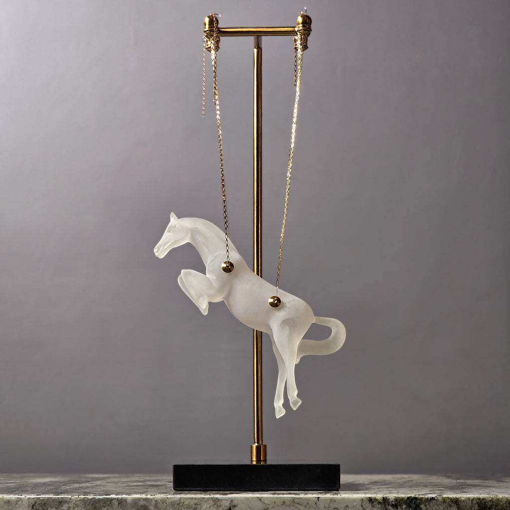Gold galloping horse decor inside black frame tabletop display