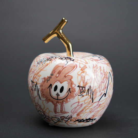 Doodle apple decor with colorful artwork and gold stem for modern playful home styling