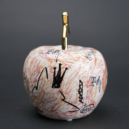 Doodle apple decor with colorful artwork and gold stem for modern playful home styling