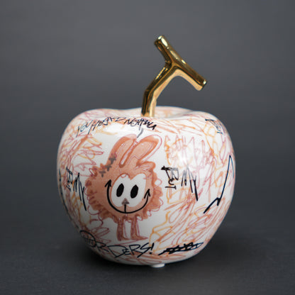Doodle apple decor with colorful artwork and gold stem for modern playful home styling