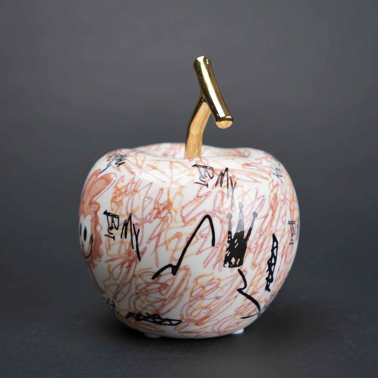 Doodle apple decor with colorful artwork and gold stem for modern playful home styling
