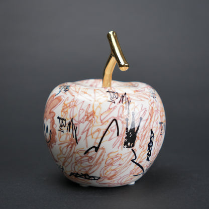 Doodle apple decor with colorful artwork and gold stem for modern playful home styling