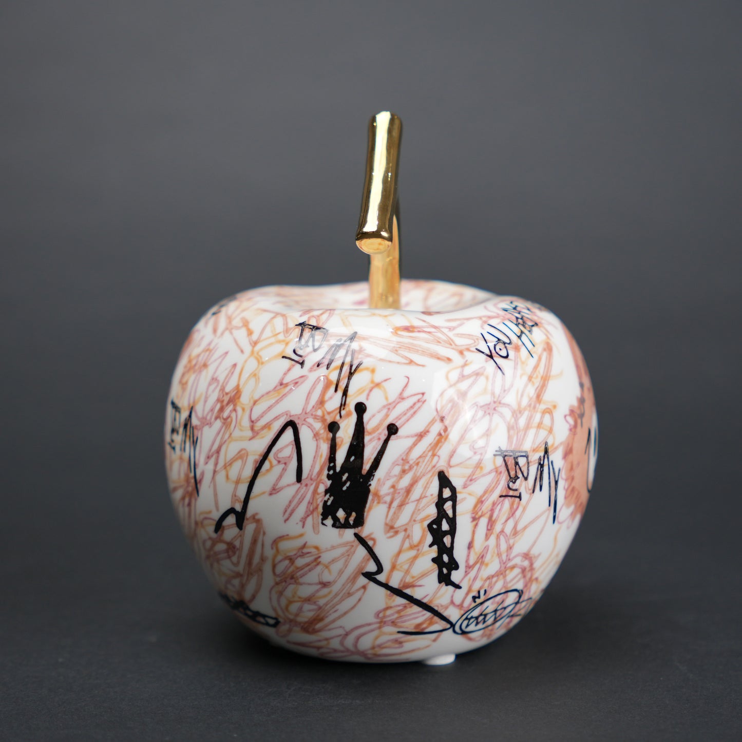 Doodle apple decor with colorful artwork and gold stem for modern playful home styling