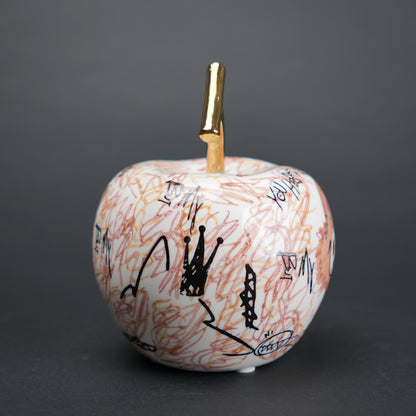 Doodle apple decor with colorful artwork and gold stem for modern playful home styling