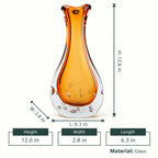 Amber clear art glass decorative vase with layered color center and elongated glass form.