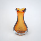 Amber clear art glass decorative vase with layered color center and elongated glass form.