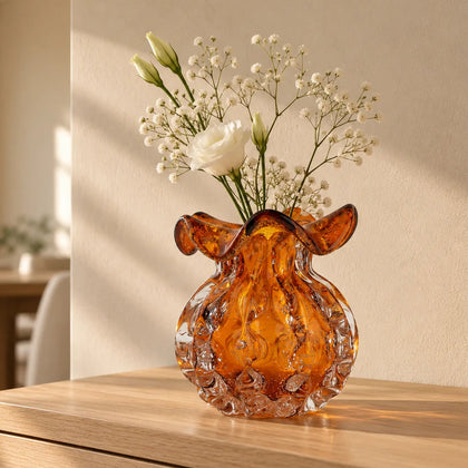 Sculptural amber-toned art glass vase with textured molten-inspired silhouette.