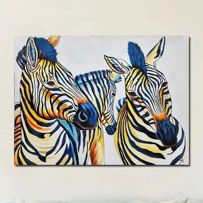 Contemporary zebra canvas painting featuring three zebras with vibrant blue, yellow, and black artistic accents.