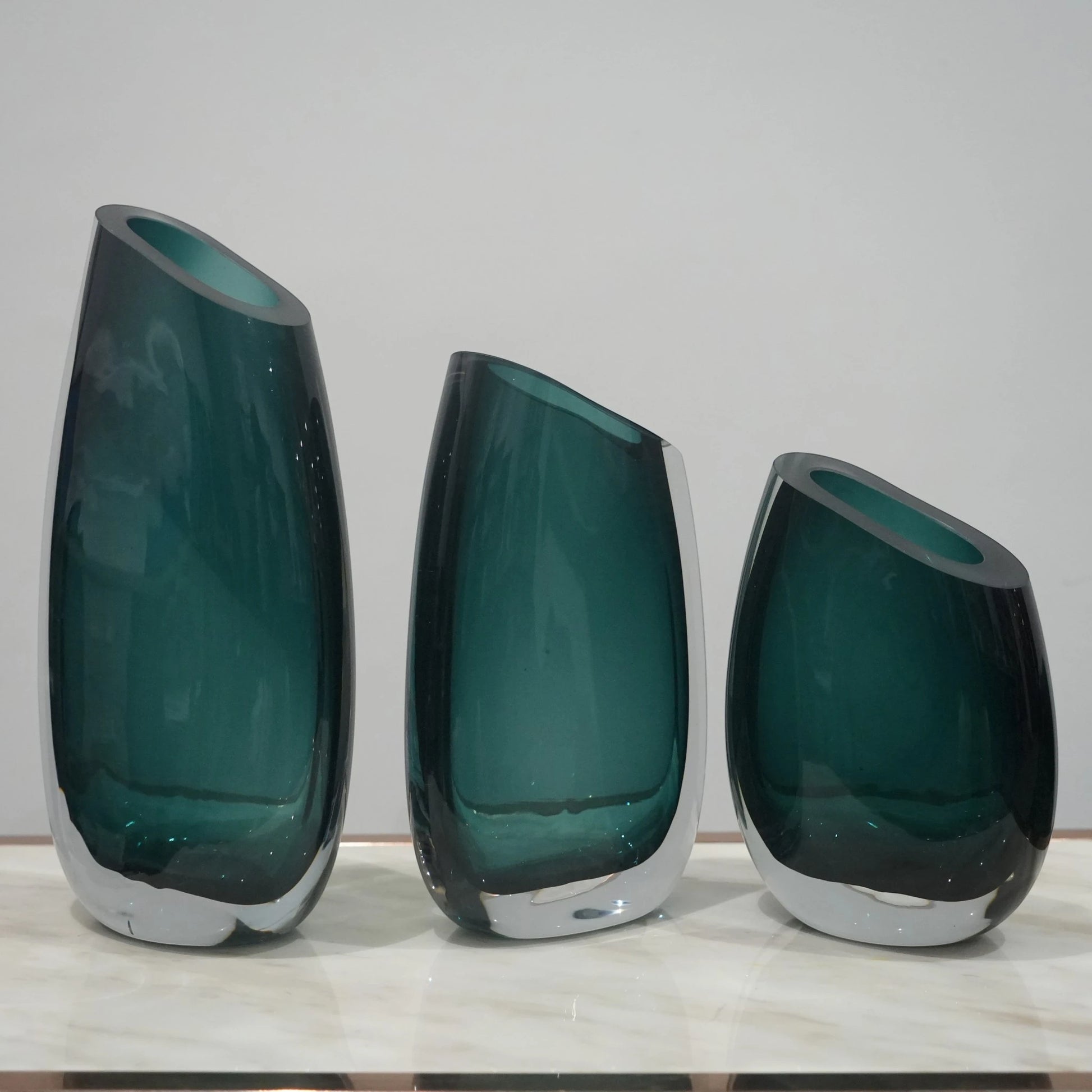Luxury hand blown glass vase with sculptural curved form and premium decorative styling for sophisticated living spaces