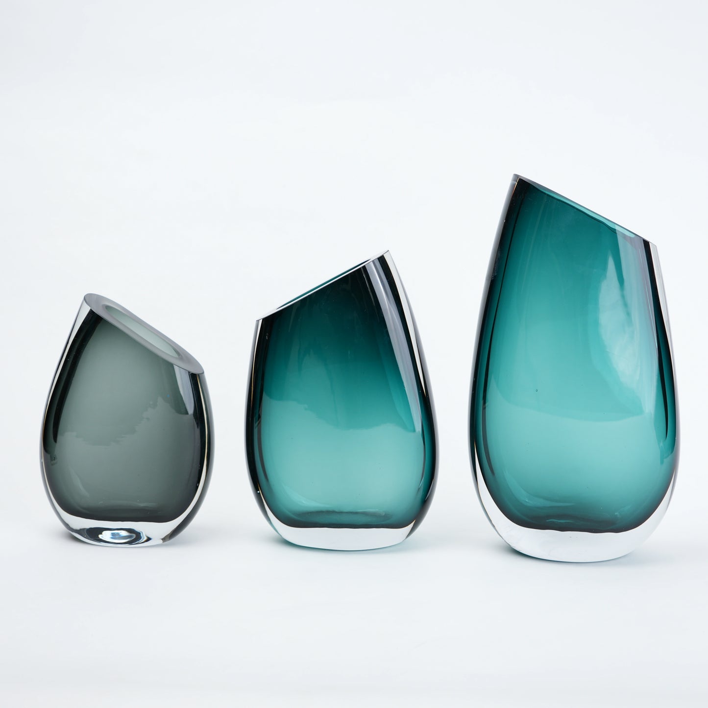 Luxury hand blown glass vase with sculptural curved form and premium decorative styling for sophisticated living spaces