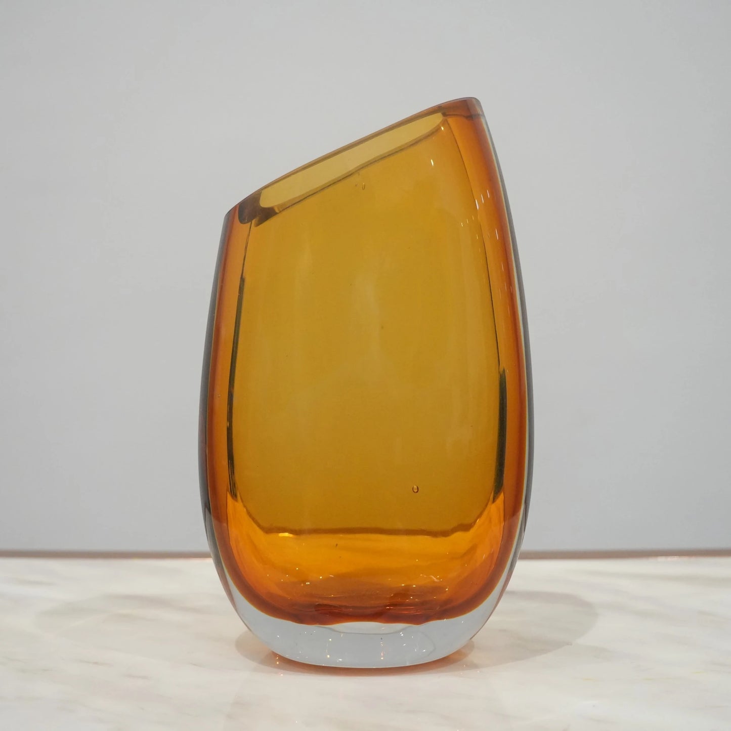 Decorative hand blown glass vase featuring organic asymmetrical form and contemporary luxury aesthetic for stylish homes