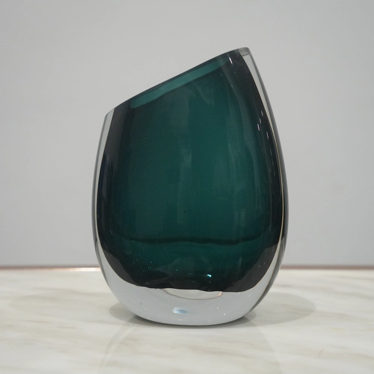 Premium teal glass flower vase with asymmetrical opening and modern luxury styling for elegant interior decor arrangements