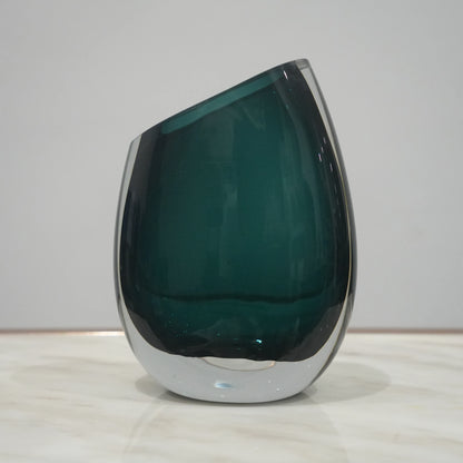 Premium teal glass flower vase with asymmetrical opening and modern luxury styling for elegant interior decor arrangements