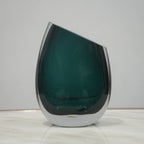 Premium teal glass flower vase with asymmetrical opening and modern luxury styling for elegant interior decor arrangements
