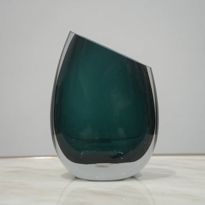 Premium teal glass flower vase with asymmetrical opening and modern luxury styling for elegant interior decor arrangements