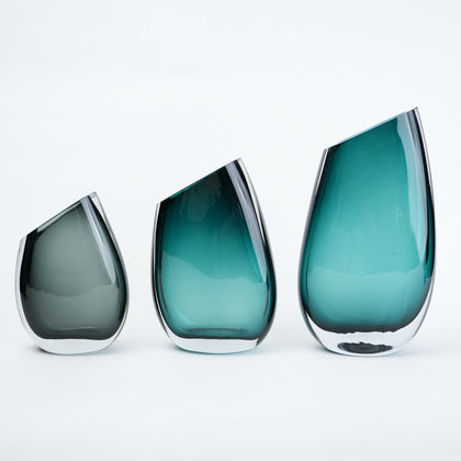Luxury hand blown glass vase with sculptural curved form and premium decorative styling for sophisticated living spaces