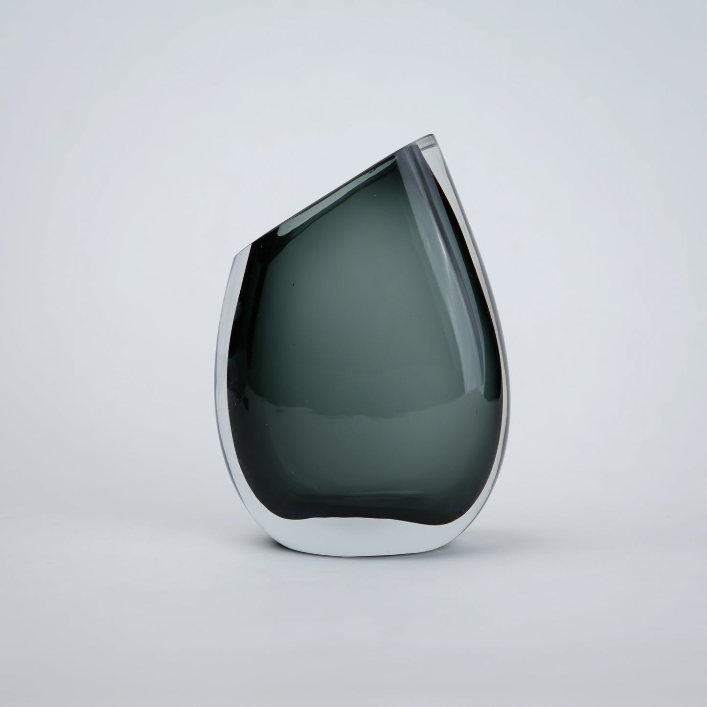 Luxury hand blown glass vase with sculptural curved form and premium decorative styling for sophisticated living spaces