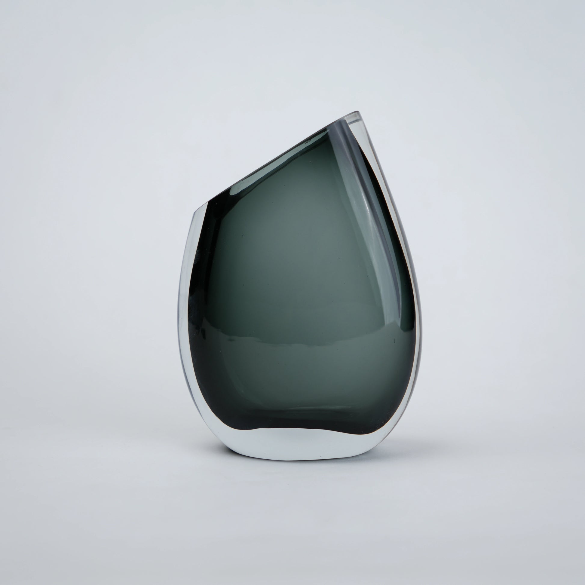Luxury hand blown glass vase with sculptural curved form and premium decorative styling for sophisticated living spaces