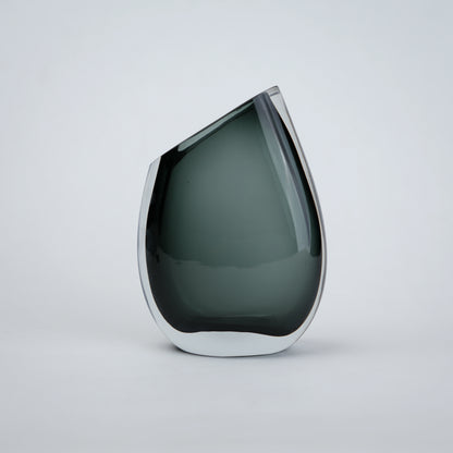 Luxury hand blown glass vase with sculptural curved form and premium decorative styling for sophisticated living spaces