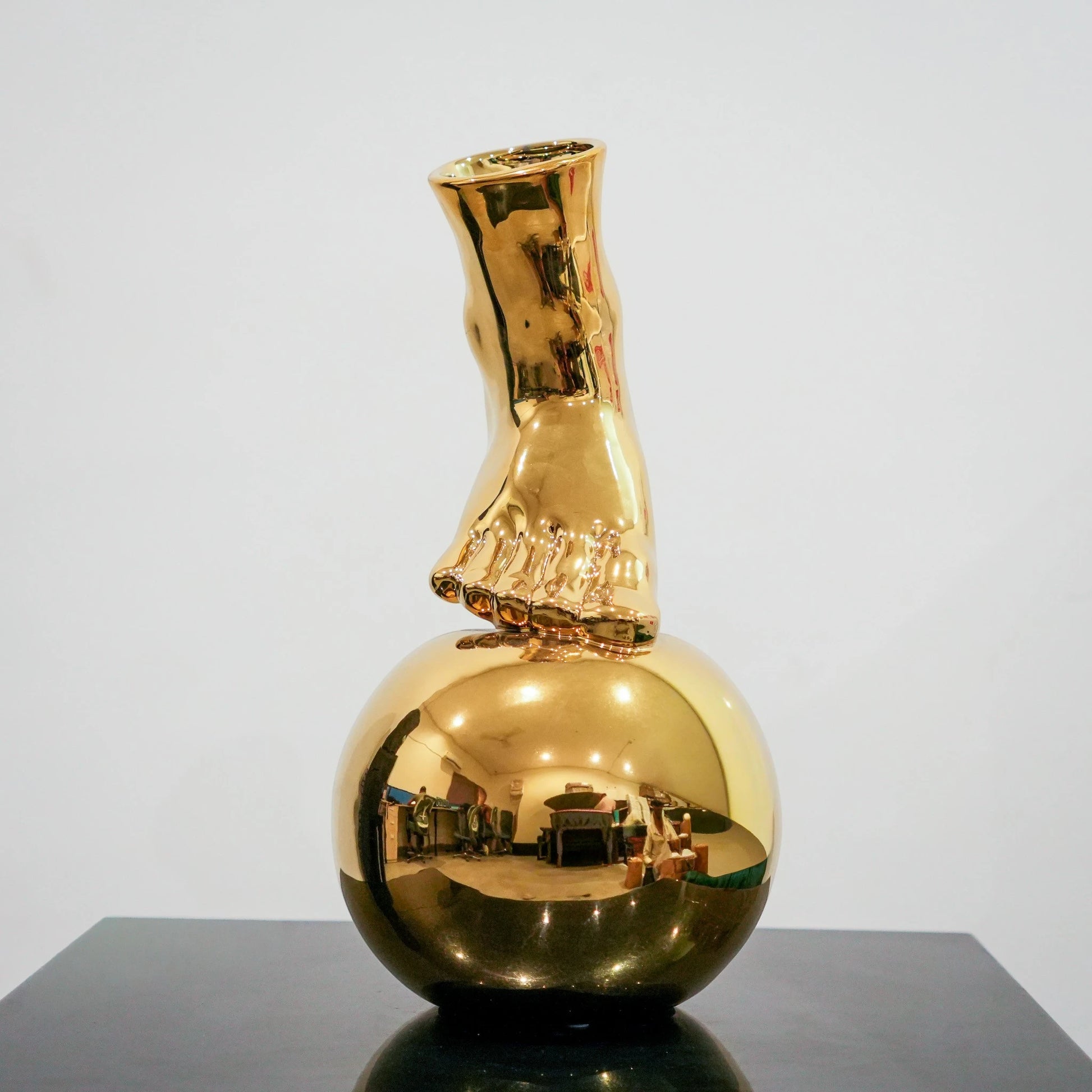 Contemporary gold ceramic vase with sculptural foot and orb design