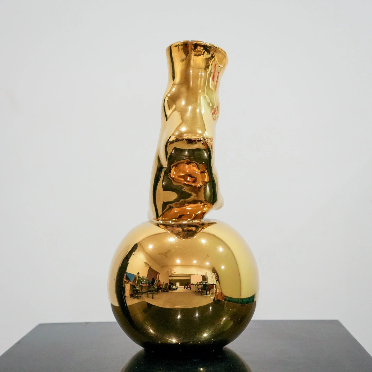 Modern decorative gold vase with foot silhouette and mirror finish