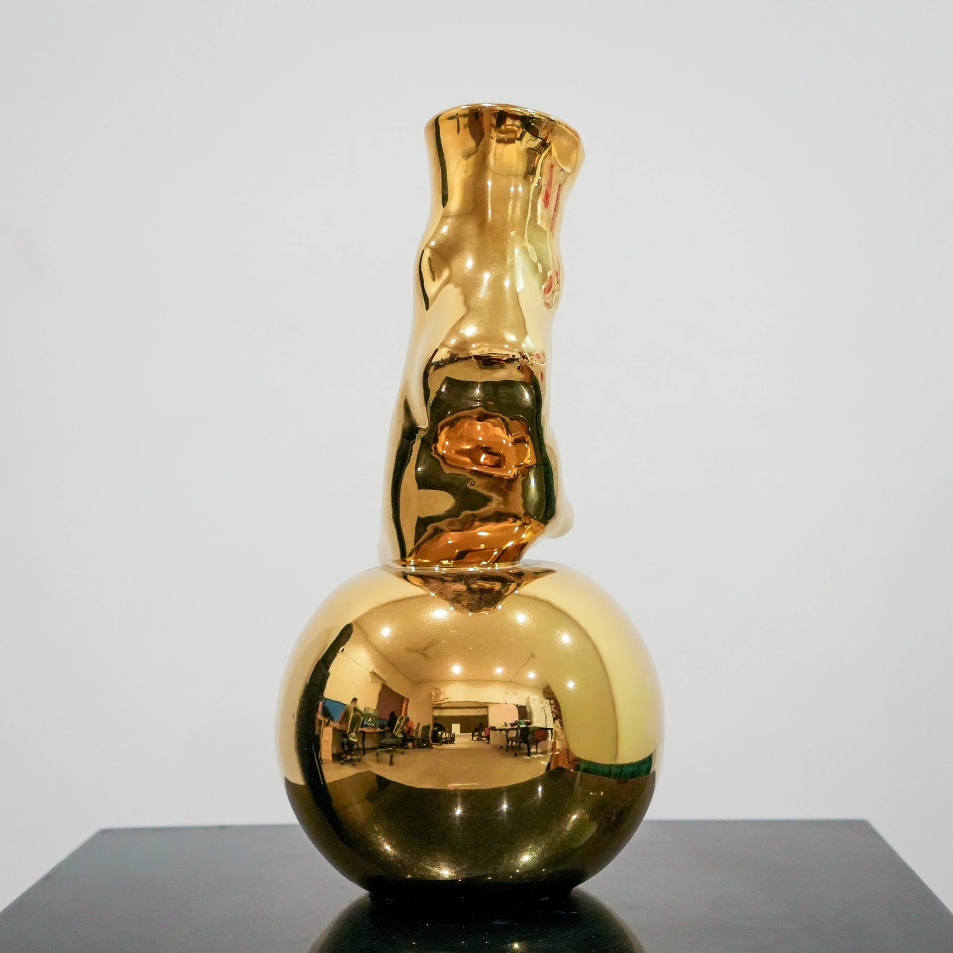 Modern decorative gold vase with foot silhouette and mirror finish
