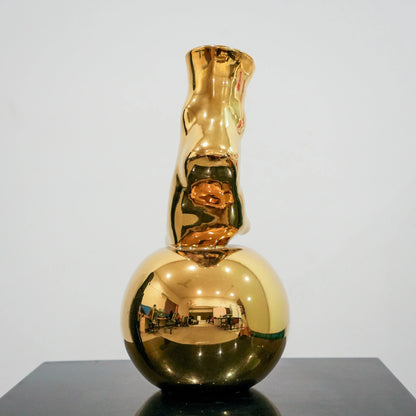 Modern decorative gold vase with foot silhouette and mirror finish