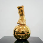 Contemporary gold ceramic vase with sculptural foot and orb design