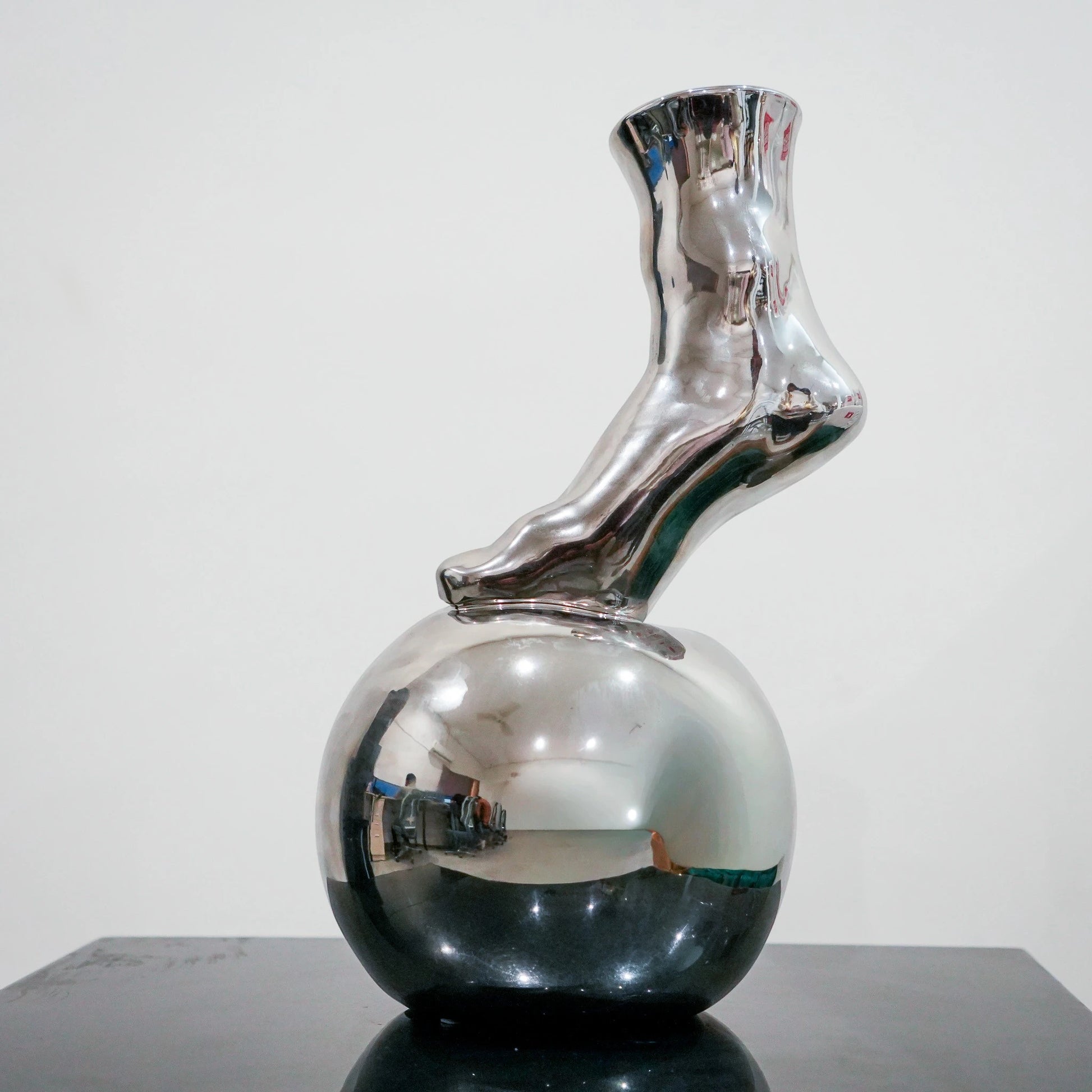 Modern decorative silver vase with foot silhouette and mirror finish