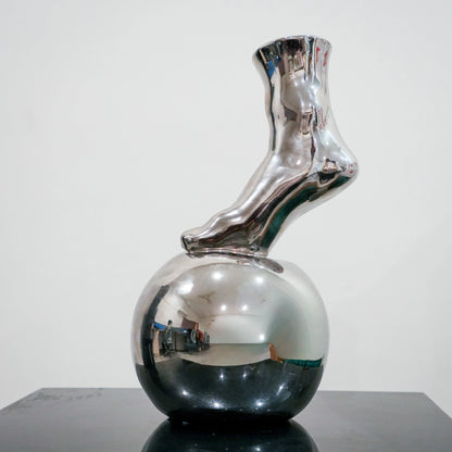 Modern decorative silver vase with foot silhouette and mirror finish