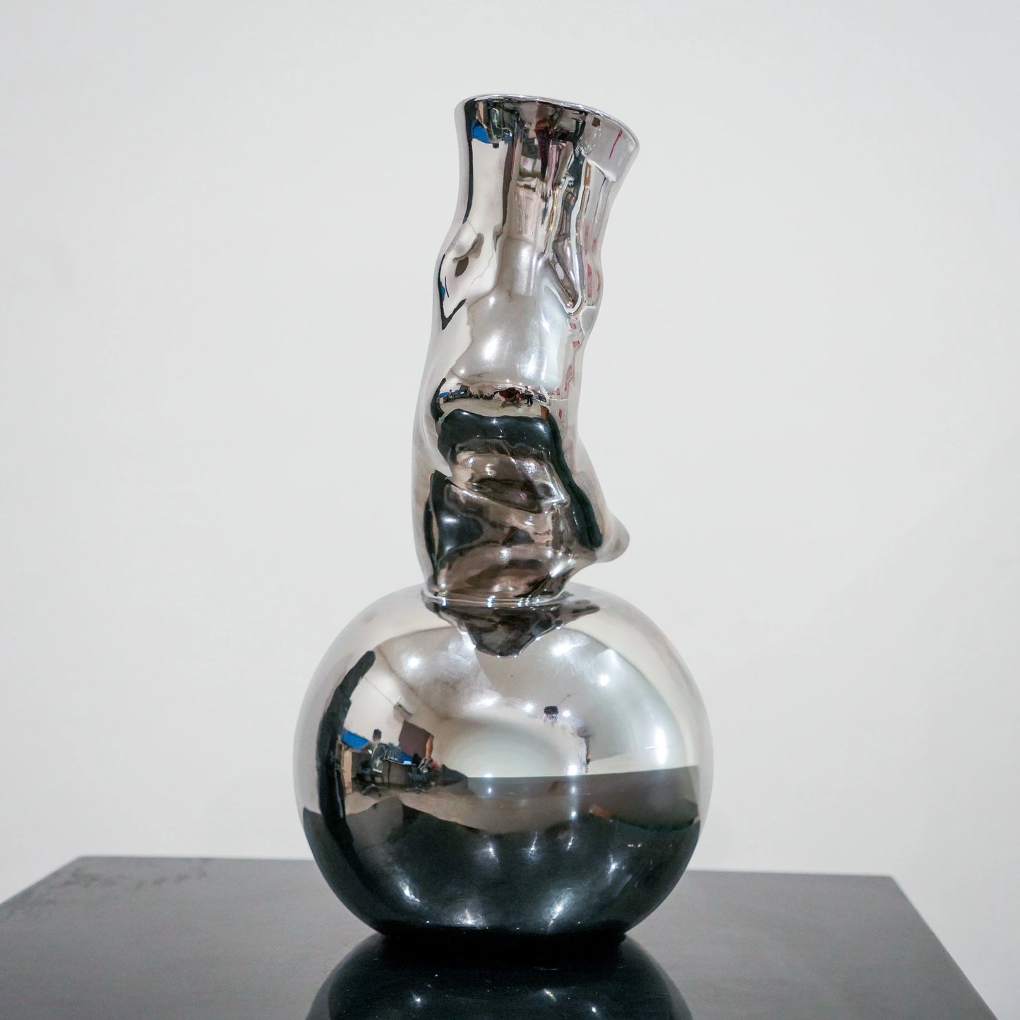 Modern decorative silver vase with foot silhouette and mirror finish