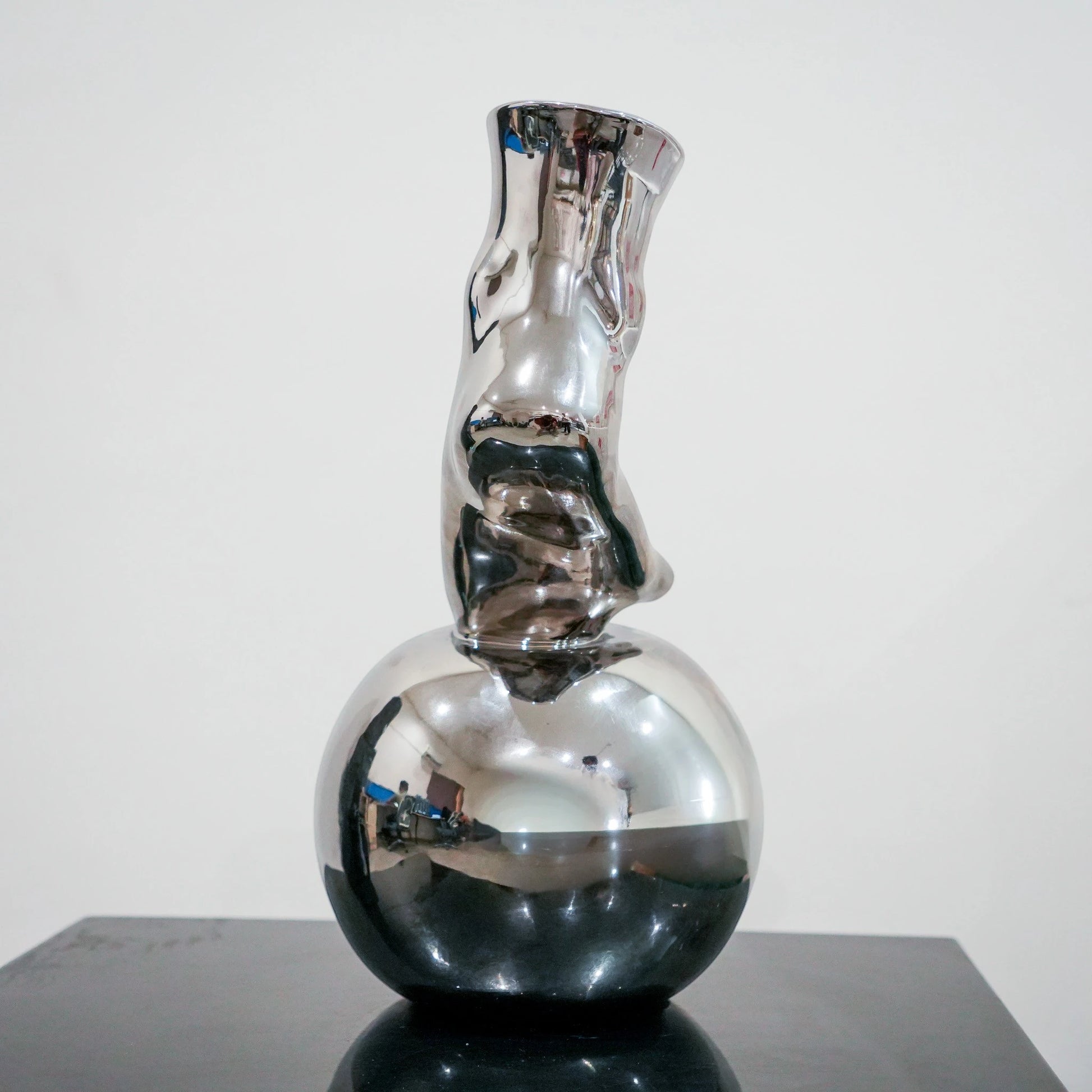 Modern decorative silver vase with foot silhouette and mirror finish