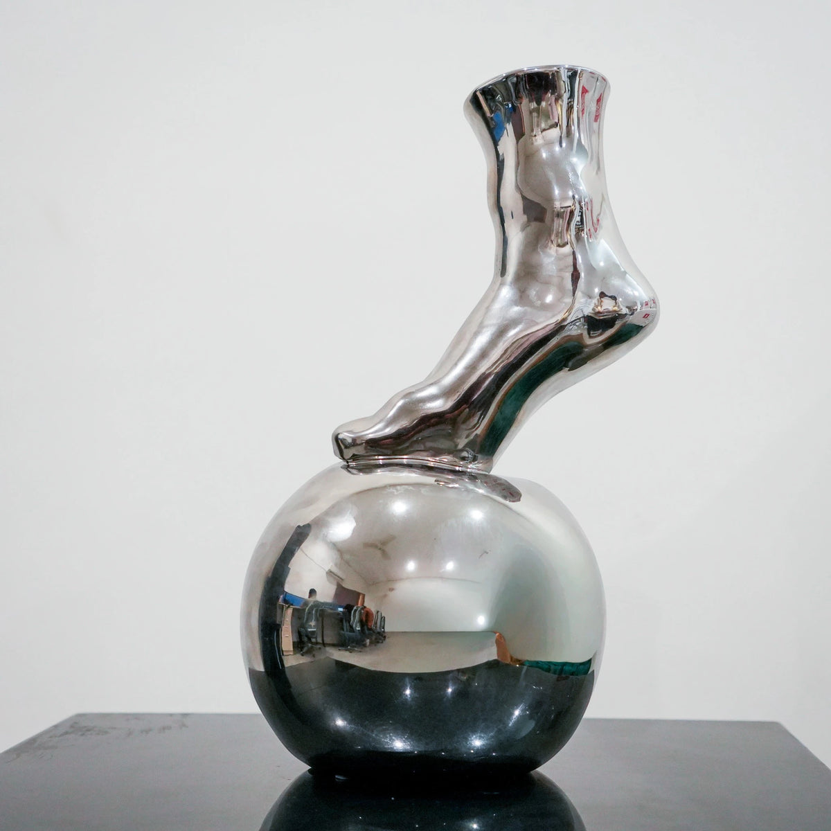 Modern decorative silver vase with foot silhouette and mirror finish
