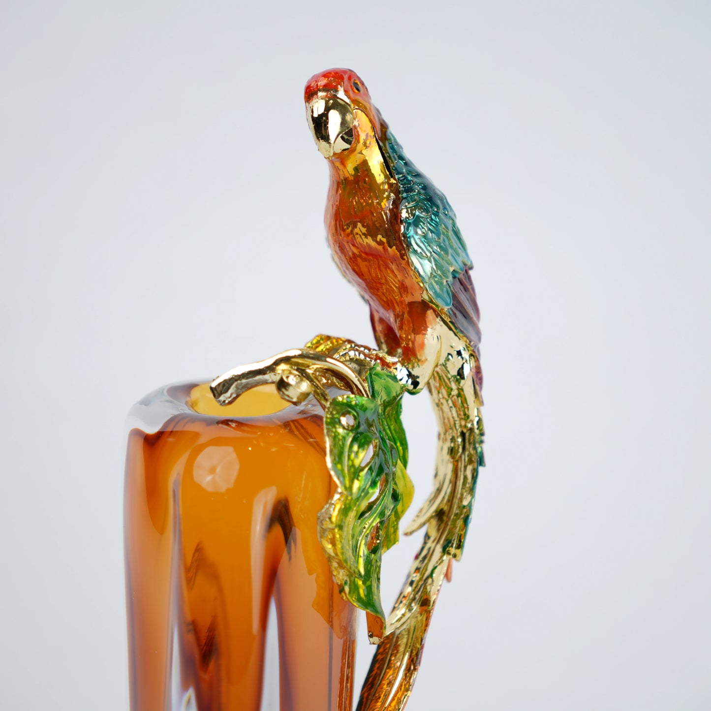 Artistic glass vase with parrot detail and transparent body for table decor