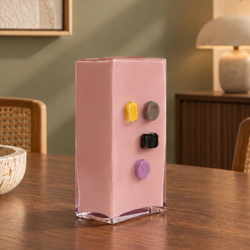 Pink art glass vase with embedded multicolor accents and wide rectangular form.
