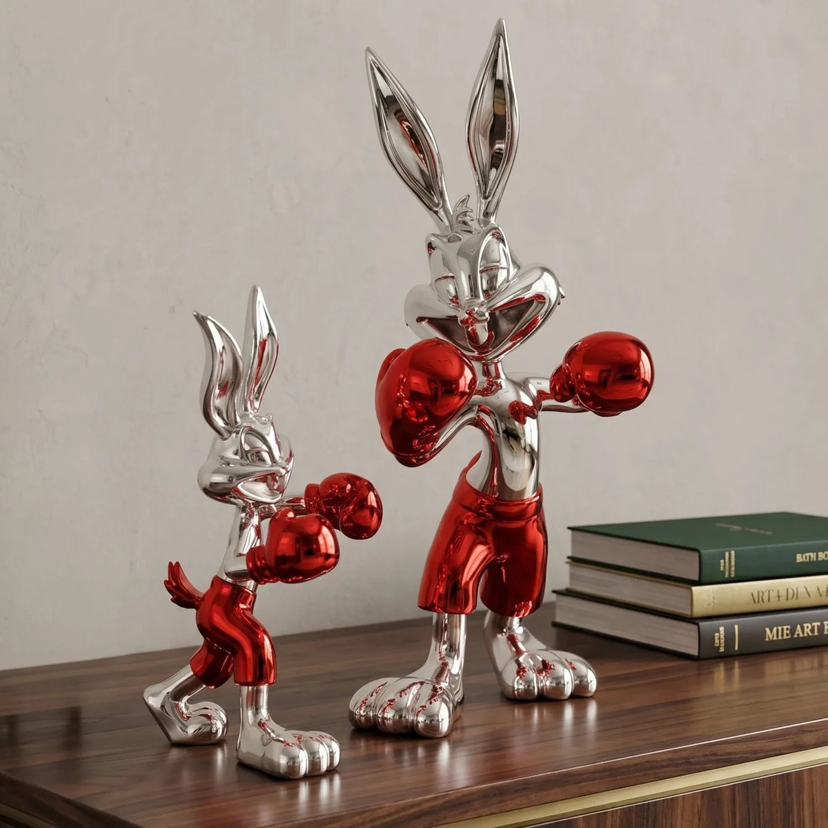 Two metallic red and silver rabbit figures on a white background