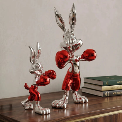 Two metallic red and silver rabbit figures on a white background