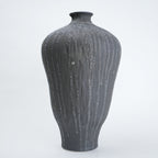 Gray textured vase on a white background