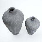 Two gray textured vases on a white background