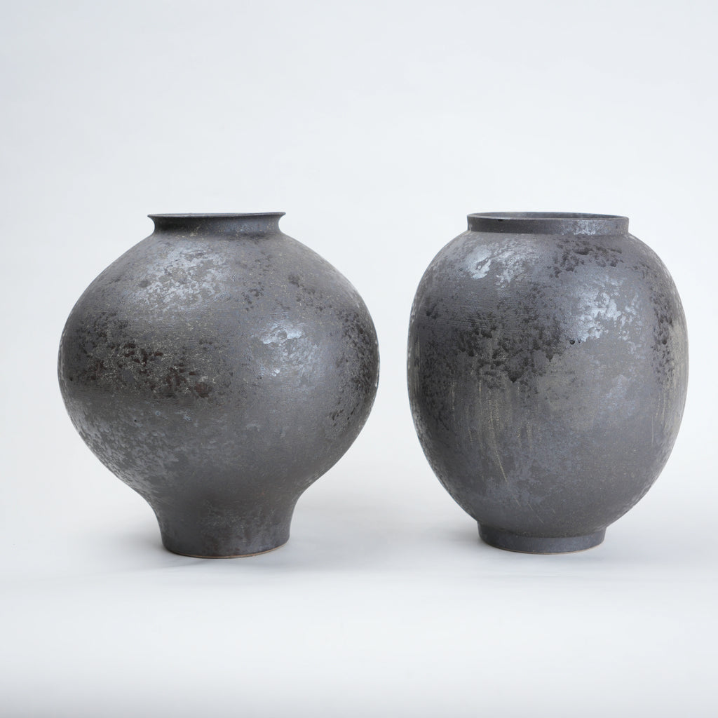 Two gray ceramic vases on a white background