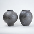 Two gray ceramic vases on a white background