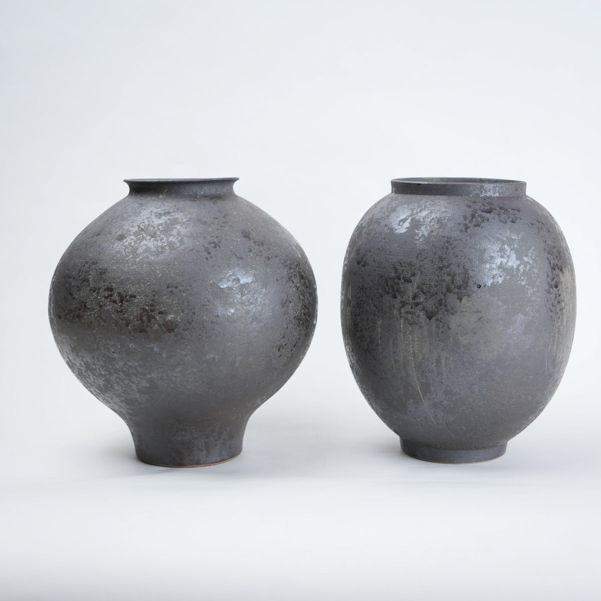 Two gray ceramic vases on a white background